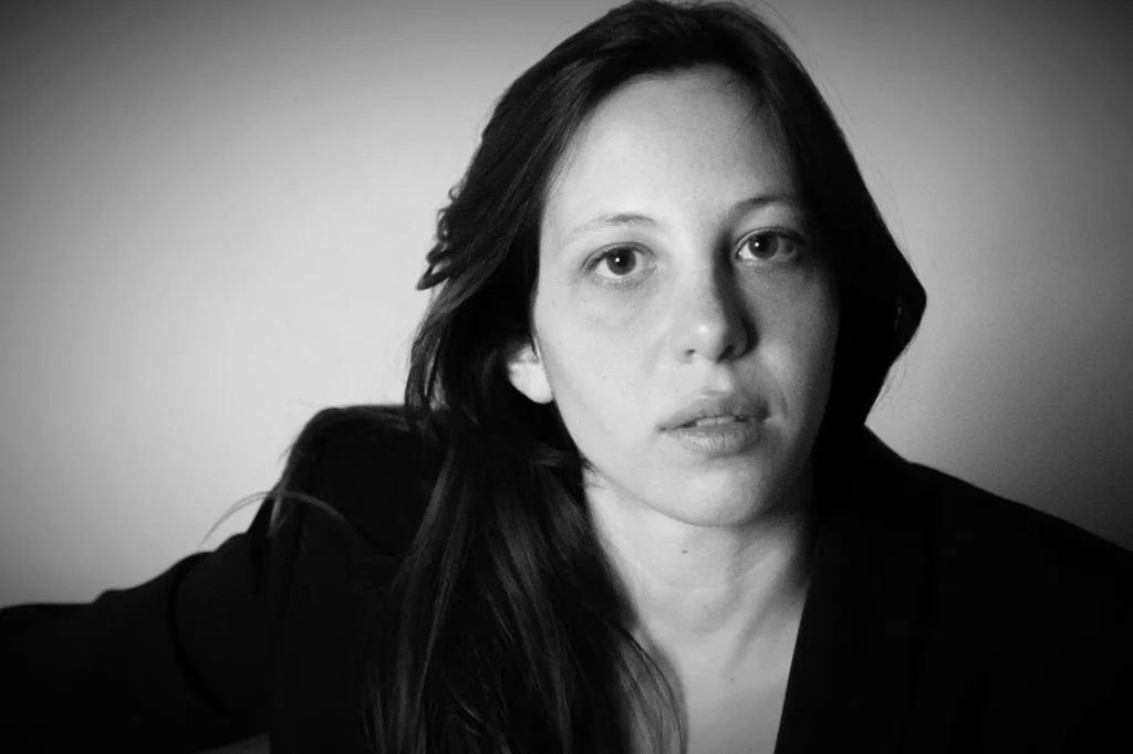 Olimpia Fortuni is a dancer and choreographer whose work explores the relationship between humans, nature, and time, often through collaborative projects and multidisciplinary approaches. Her career includes performing with notable choreographers, creating award-winning solo and group works, and engaging in research residencies internationally, demonstrating a commitment to both performance and artistic exploration.