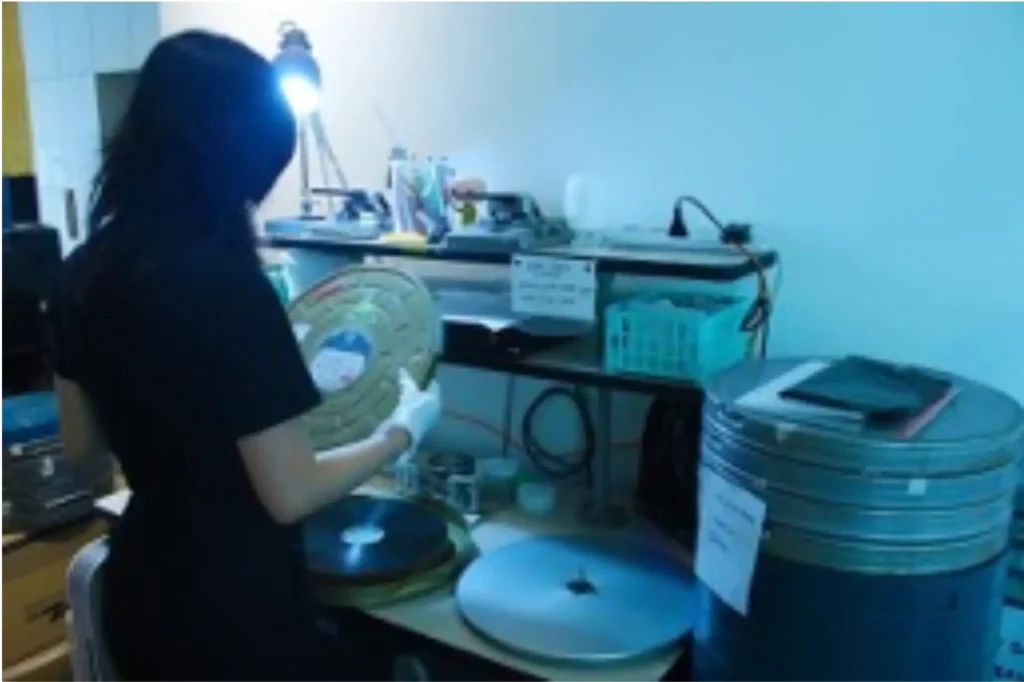 Inspecting the condition of a film reel © Asian Film Archive