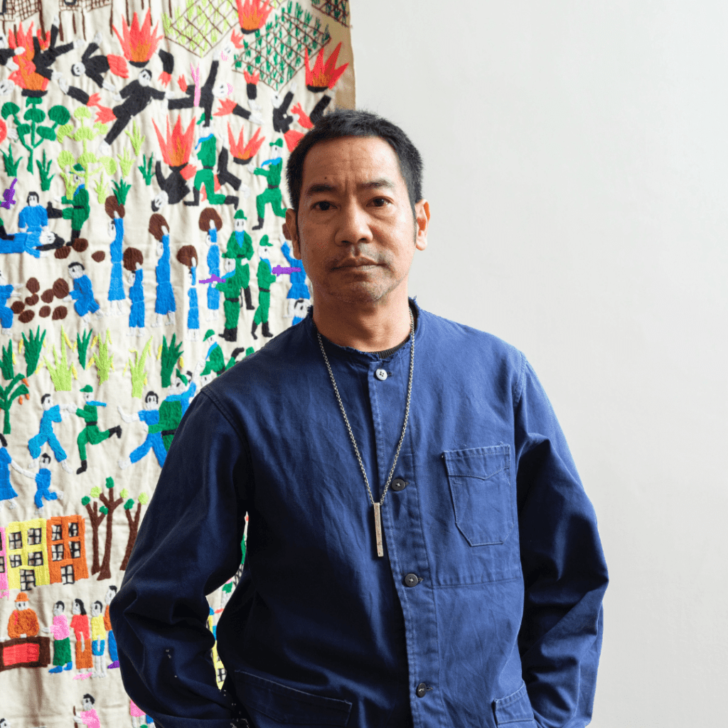 Born in 1969 in Bangkok, Jakkai Siributr works across media, with a special focus on textile and sewing, adopted for their tactile and interactive features. His intricately sewn and embroidered tapestries and installations convey powerful responses to contemporary and historical societal issues in Thailand and beyond, revolving around migration and personal stories of grief and remembrance. Siributr’s immersive practice highlights overlooked and neglected histories of groups that have been largely ignored, in recent years addressing the experiences of ethnic minorities who are displaced refugees.