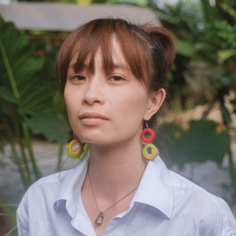 RED is a video artist and independent art producer working across dance, theater, experimental music, and interdisciplinary art whose works aim at re-examining the meaning of “dance” in the Vietnamese context, creating safe spaces for performance practices that defy established systems, and opening possibilities for artists to explore alternative ways of thinking and creating performance work. Red co-founded and is co-directing MORUA (an artist-driven residency focused on supporting young local performance makers) and PROJECT ĐẨY SÀN (a Saigon-based project focused on learning, collaboration, and experimentation for new performance makers).   Red has curated and produced projects such as Dealing in Distance (mini traveling festival by Goethe Institut Hanoi, Ho Chi Minh City, Jakarta, Manila, 2025-2026). She collaborates with Southeast Asian artists and producers through initiatives like MORASUM (co-founded by producers from Thailand, Vietnam, Malaysia, Singapore, the Philippines and South Korea) and Southeast Asia Choreographer Networks (SEACN).